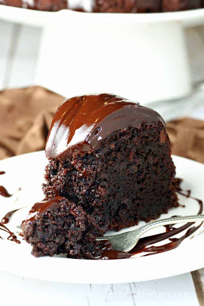 Slice of chocolate fudge bundt cake with chocolate ganache frosting.