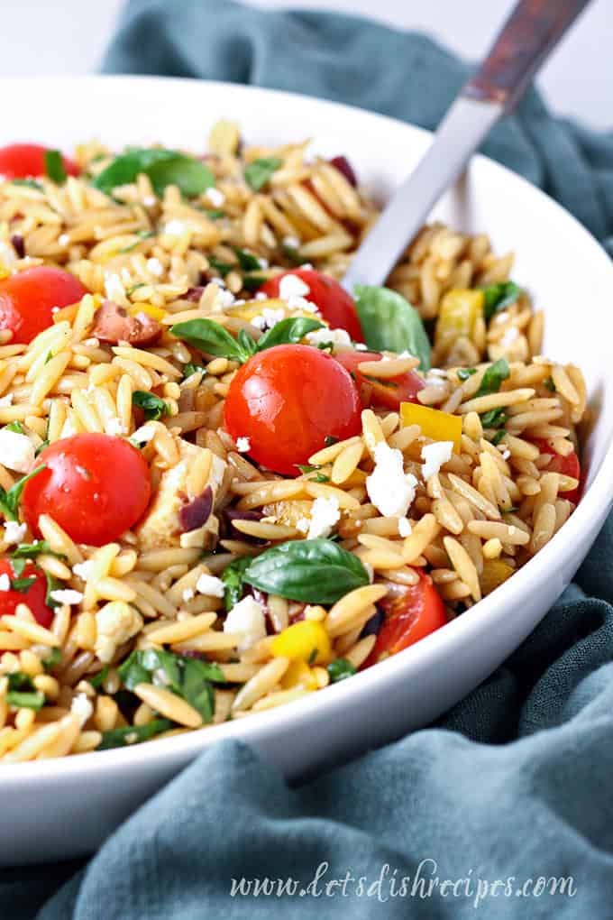 Mediterranean orzo salad with tomatoes, olives, feta and herbs.