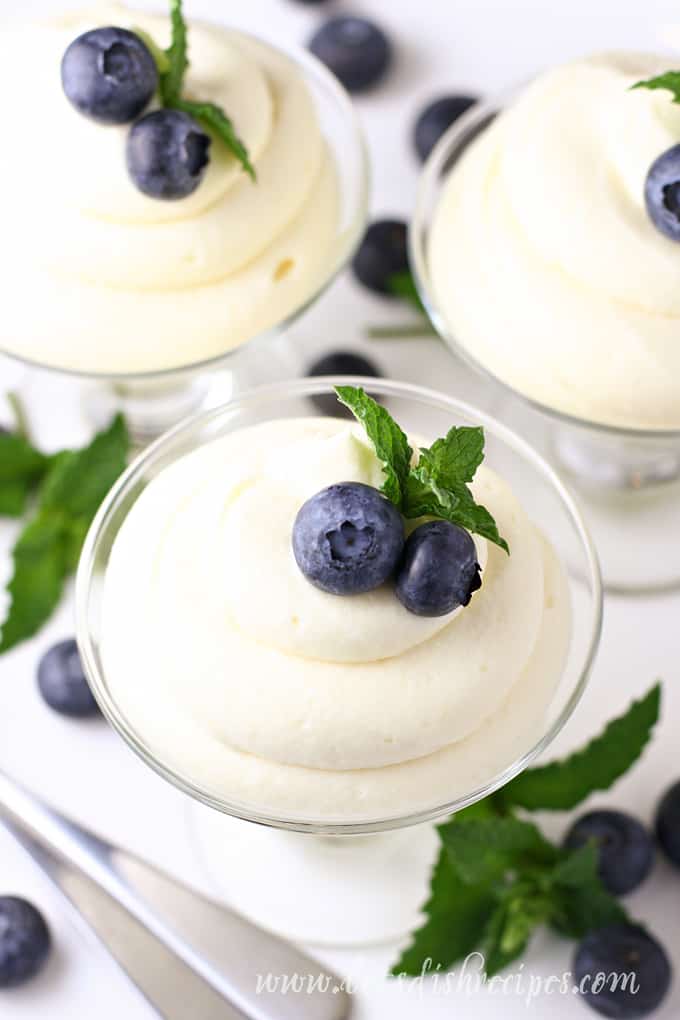 Lemon cheese cake mousse, piped into a dessert glass and topped with blueberries and mint.