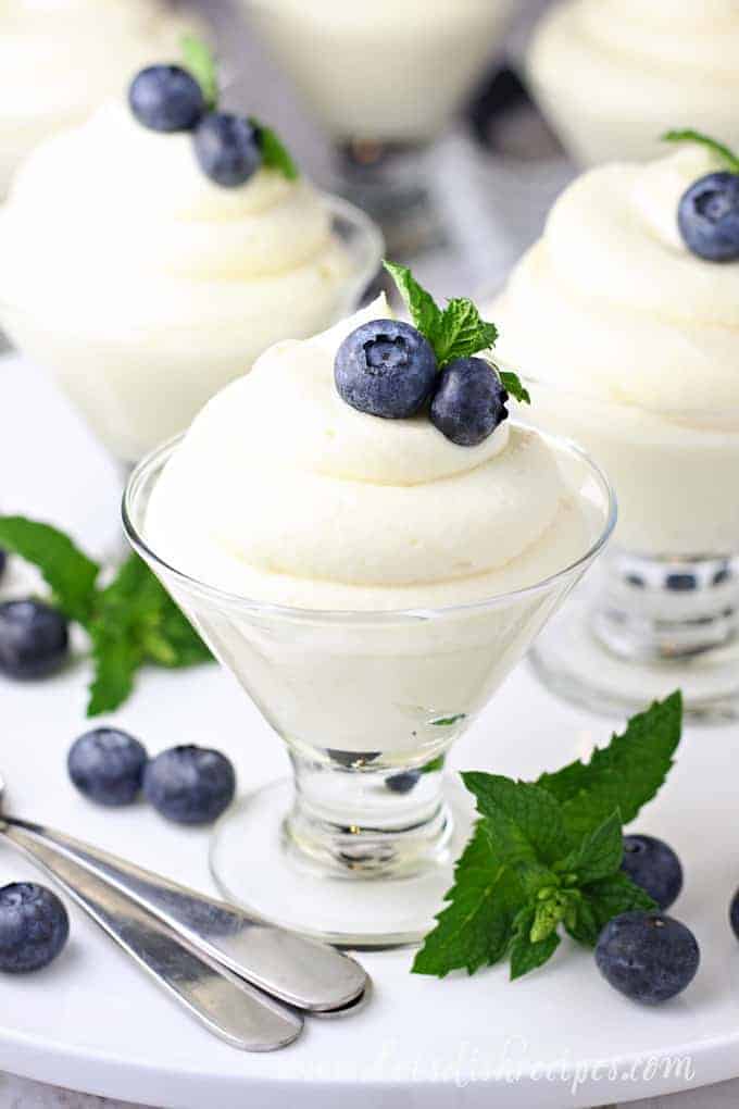 Lemon cheese cake mousse, piped into a dessert glass and topped with blueberries and mint.