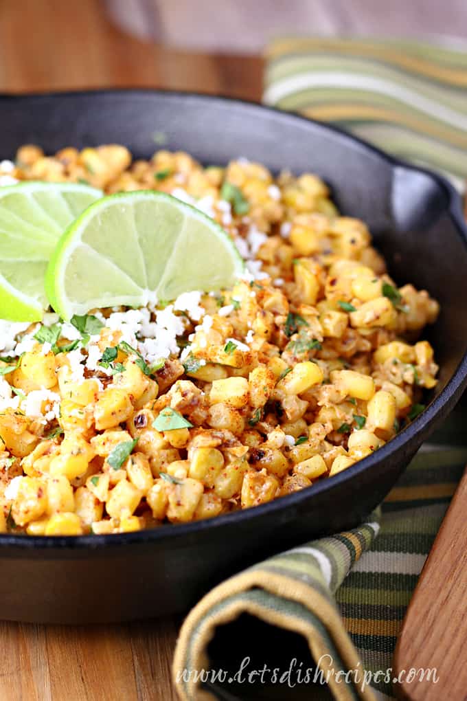 Mexican Street Corn Mexican street corn in cast iron skillet with limes.(Torchy's Copycat)