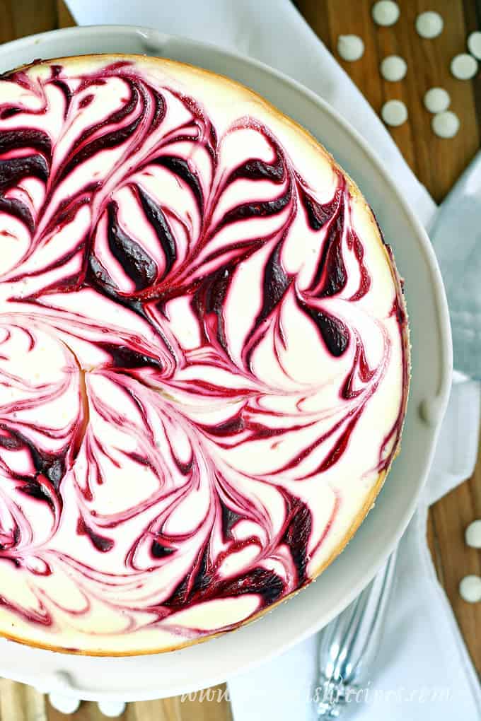 White chocolate cheesecake with a raspberry swirl on top.