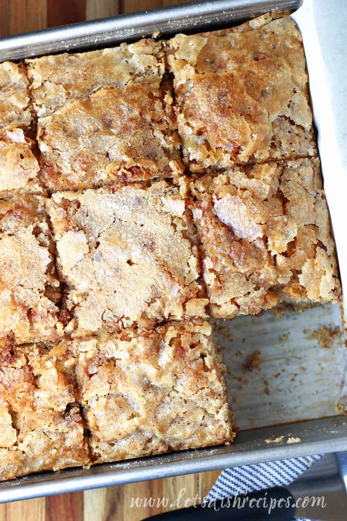 Banana bread cake in square pan with crunchy sugar topping.