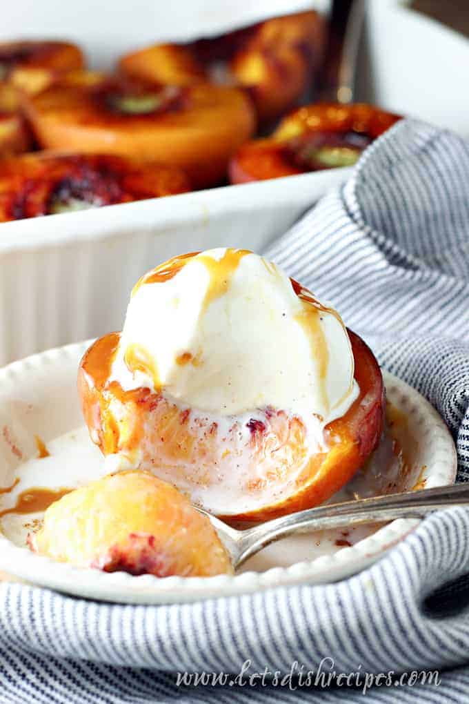 Peaches are halved, sprinkled in brown sugar and spices, then baked and topped with vanilla ice cream.