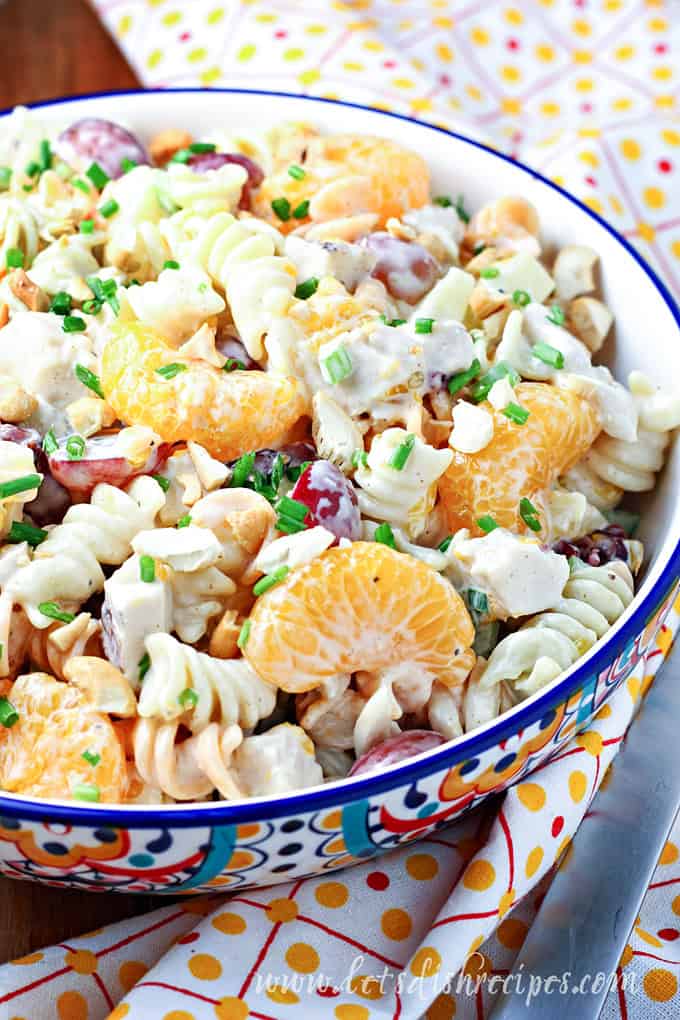 Pasta salad with chicken, pineapple and mandarin oranges in colorful bowl.